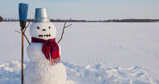  — © Lonely snowman at a snowy field at winter time